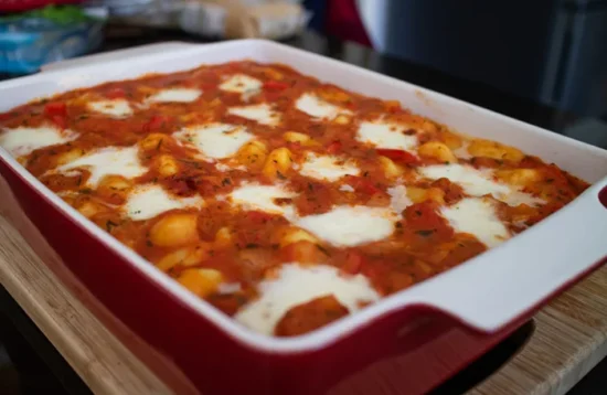 Chorizo & mozzarella gnocchi bake in a red baking dish