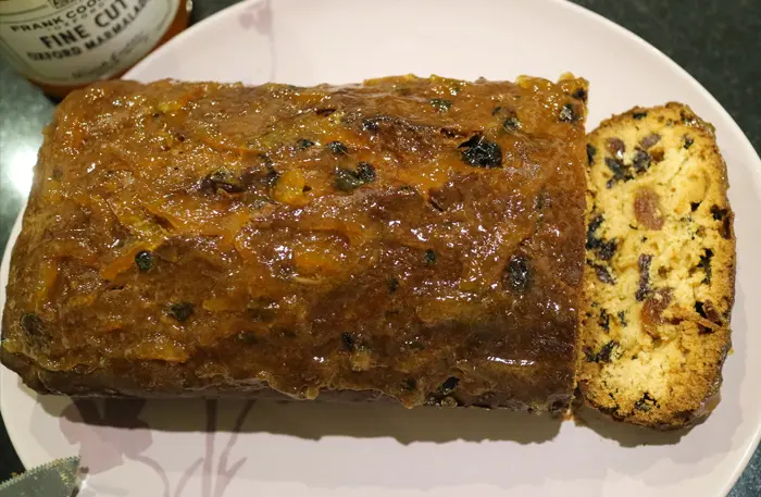 The baked Marmalade cake, on a plate with a slice already cut.