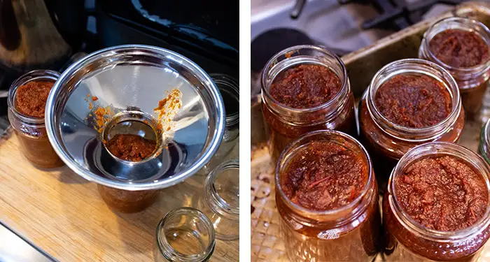 A jam funnel is sitting on a jar being filled with the Smoky Tomato Chilli Chutney