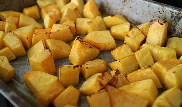 The oven roasted butternut squash in a roasting tin