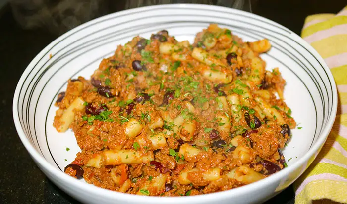 The finished One Pot Vegetarian Chili Mac and Cheese recipe, dished up in a white bowl. 